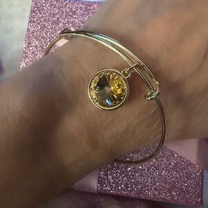 Bright yellow stone on gold colored  bracelet